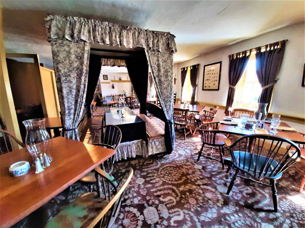 Tester-bed dining and nearby tables in the upstairs Bedroom dining area.