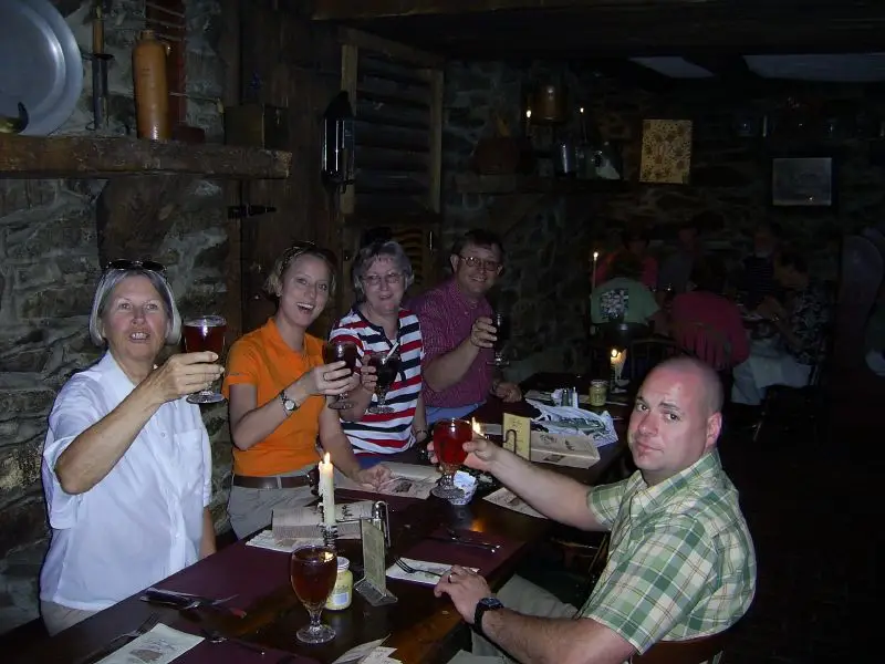 A group of visitors raising glasses around a table inside Dobbin House.